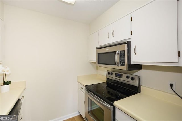 kitchen with stainless steel appliances and white cabinetry