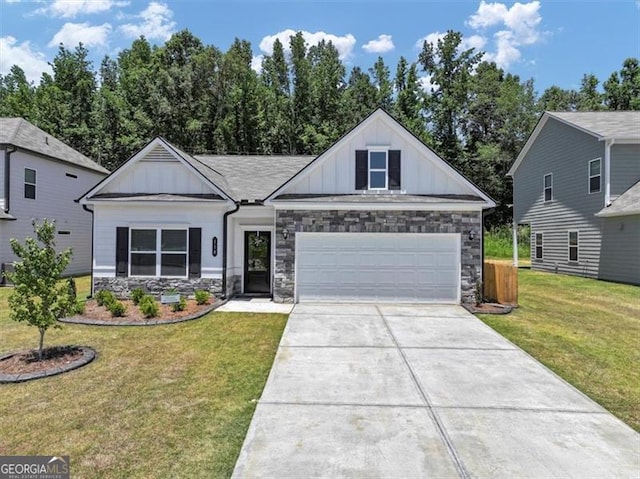 view of front of property with driveway, a front lawn, board and batten siding, and stone siding