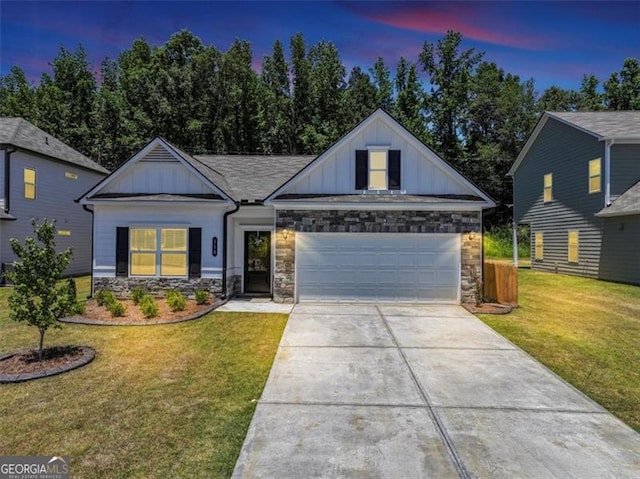 view of front of home featuring concrete driveway, board and batten siding, an attached garage, and a lawn