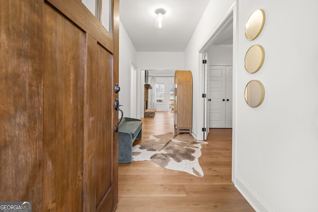 corridor with light hardwood / wood-style floors