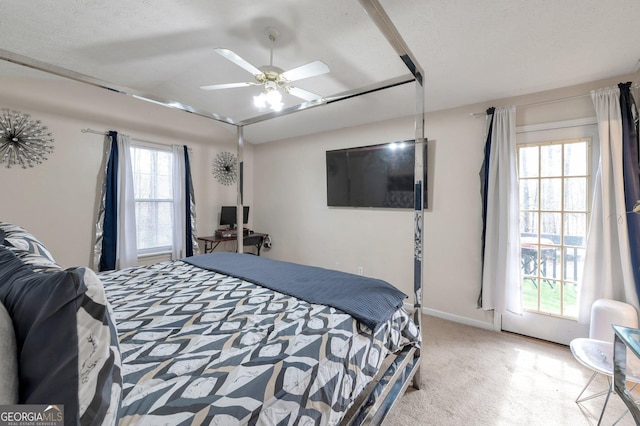 bedroom featuring multiple windows, light colored carpet, ceiling fan, and lofted ceiling