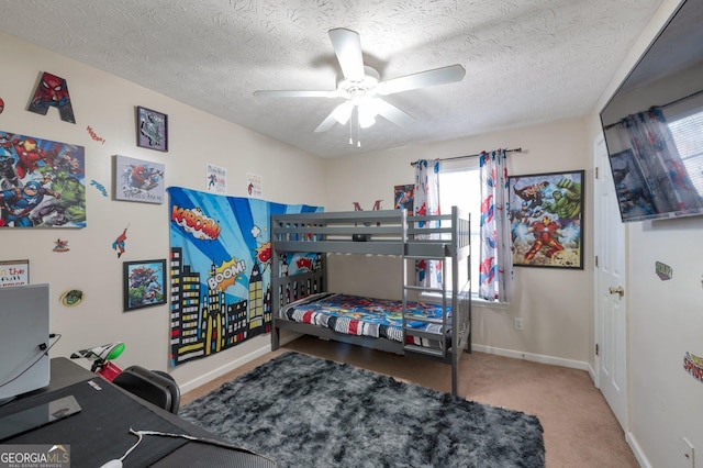 bedroom featuring ceiling fan, a textured ceiling, and carpet flooring