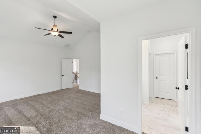 interior space with vaulted ceiling and light carpet