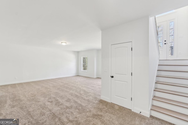 interior space featuring light carpet