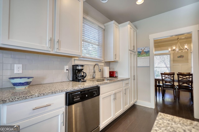 kitchen with dark wood-type flooring, sink, light stone counters, dishwasher, and white cabinets