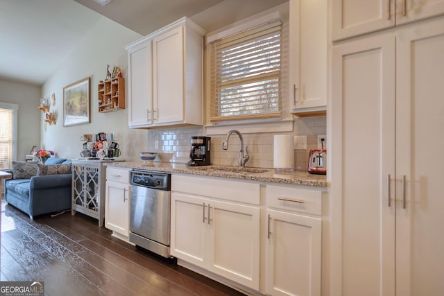 kitchen with white cabinetry, stainless steel dishwasher, dark hardwood / wood-style flooring, and backsplash