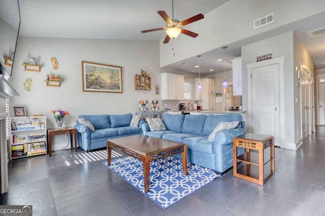 living room featuring lofted ceiling, dark hardwood / wood-style floors, and ceiling fan