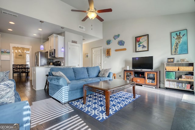 living room with high vaulted ceiling, dark hardwood / wood-style floors, and ceiling fan