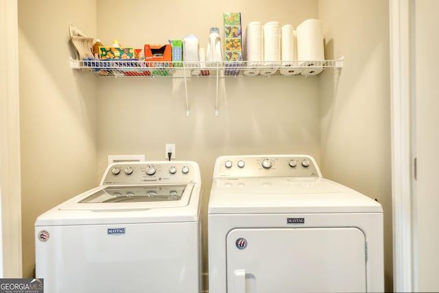 laundry room with washing machine and clothes dryer