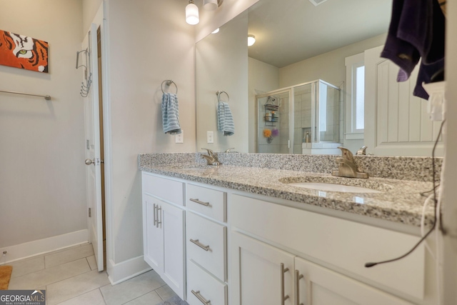 bathroom featuring an enclosed shower, vanity, and tile patterned floors