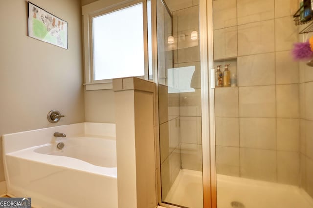 bathroom featuring independent shower and bath
