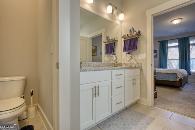 bathroom featuring vanity, tile patterned floors, and toilet
