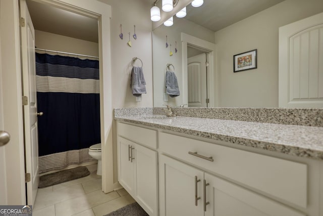 bathroom with vanity, toilet, and tile patterned flooring