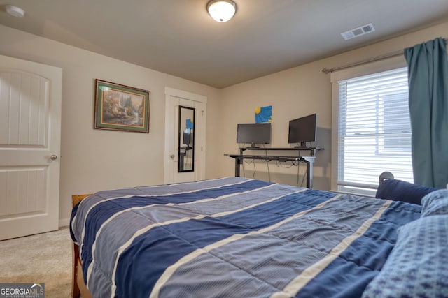 bedroom with light colored carpet