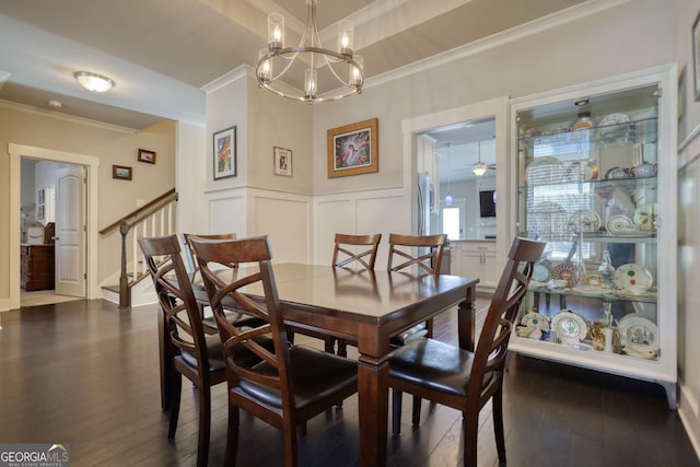 dining area featuring crown molding, dark hardwood / wood-style floors, and ceiling fan with notable chandelier