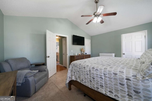 carpeted bedroom with vaulted ceiling and ceiling fan