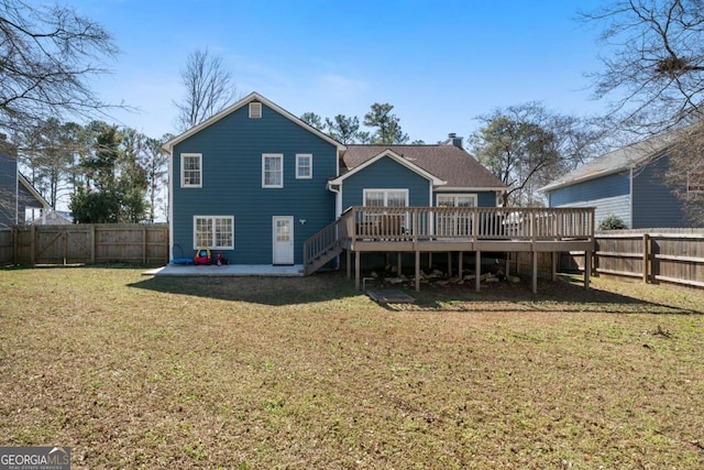 back of house featuring a yard and a deck