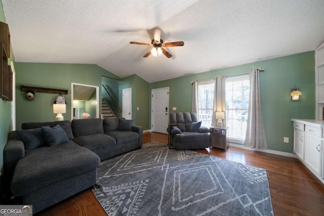 living room with ceiling fan, lofted ceiling, a textured ceiling, and dark hardwood / wood-style flooring