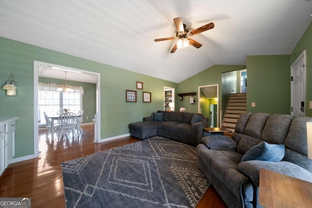 living room featuring ceiling fan with notable chandelier, dark hardwood / wood-style flooring, and vaulted ceiling