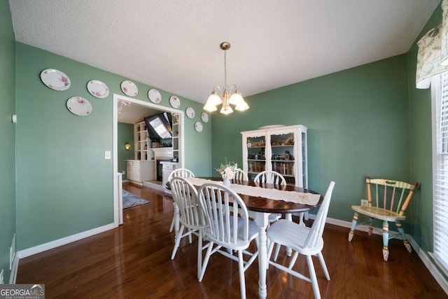 dining room with an inviting chandelier and dark hardwood / wood-style flooring