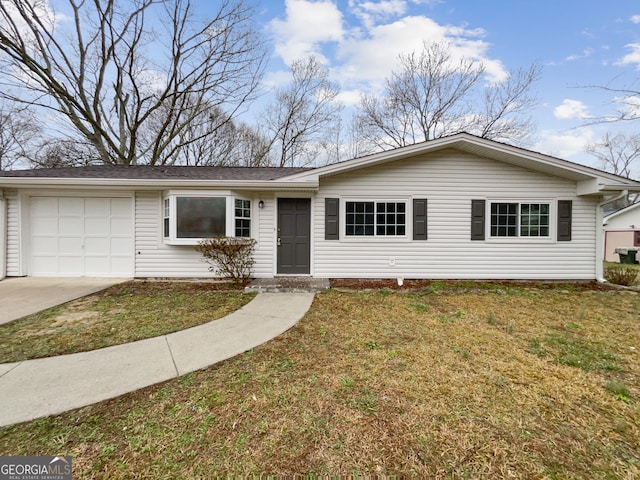 ranch-style house featuring a garage and a front yard