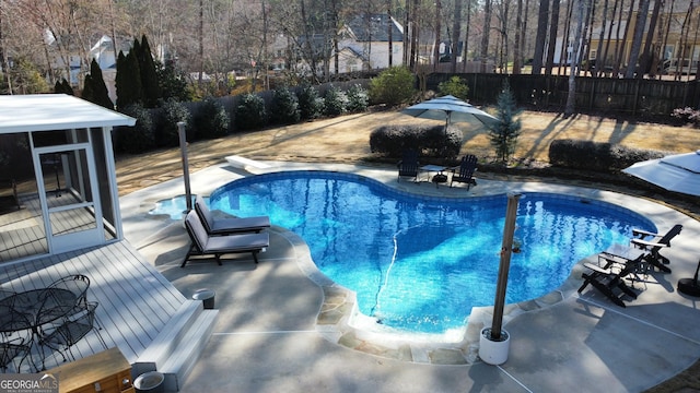 view of swimming pool featuring a deck