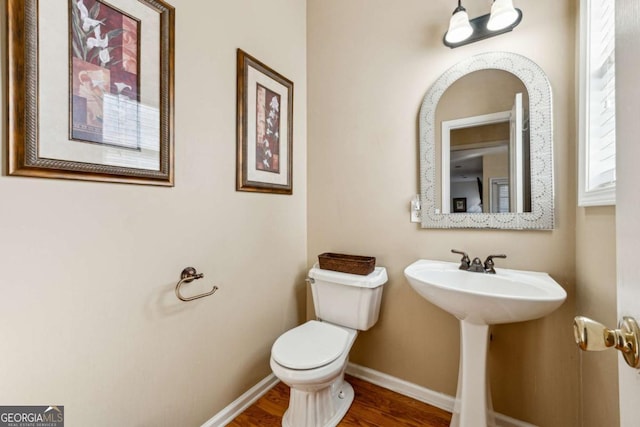 bathroom with sink, hardwood / wood-style flooring, and toilet