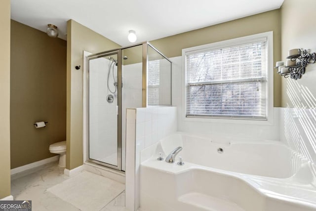 bathroom with toilet and shower with separate bathtub