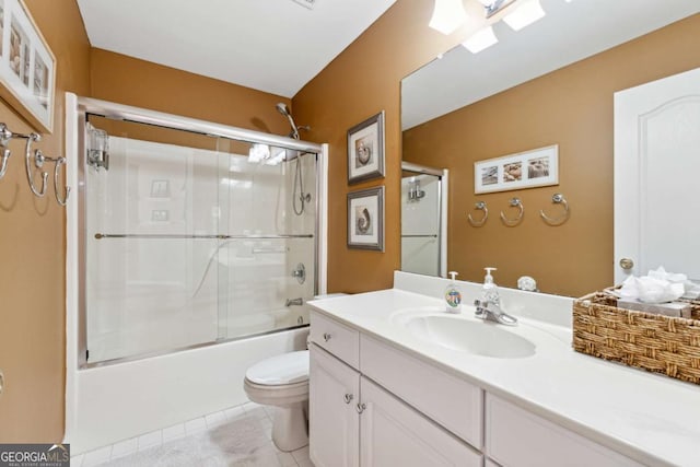 full bathroom featuring vanity, tile patterned floors, toilet, and combined bath / shower with glass door