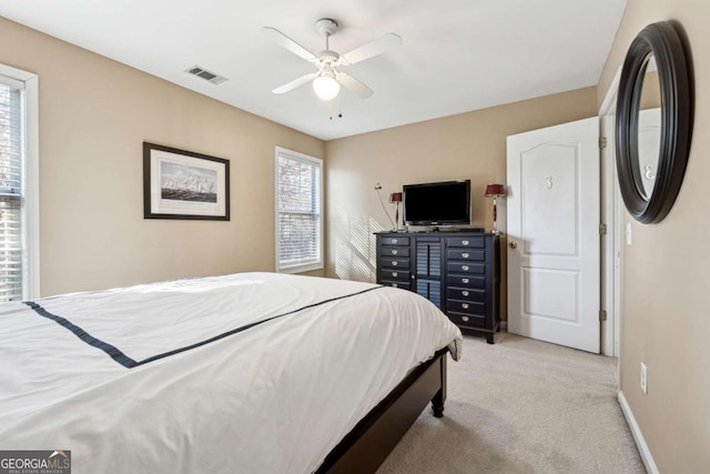 bedroom with ceiling fan and light colored carpet