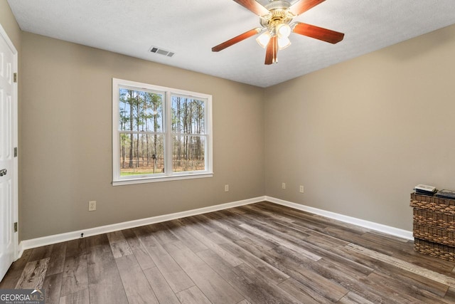 unfurnished bedroom featuring wood-type flooring, a textured ceiling, and ceiling fan