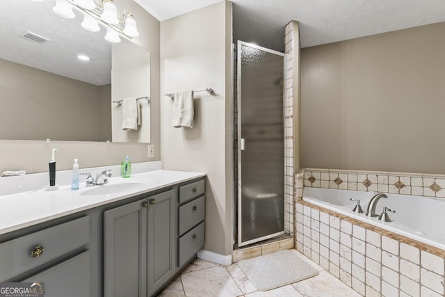 bathroom with independent shower and bath, vanity, a notable chandelier, and a textured ceiling