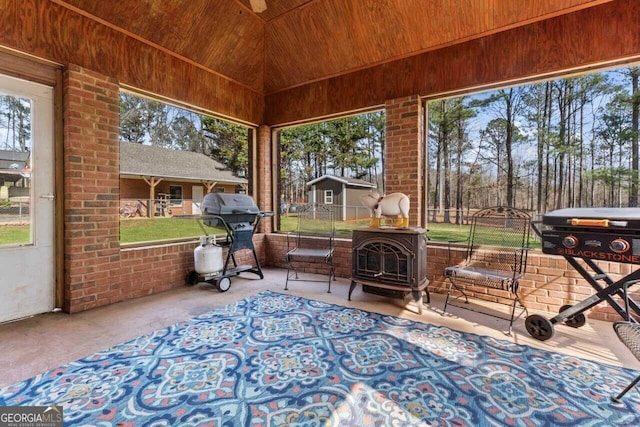 sunroom with a wood stove