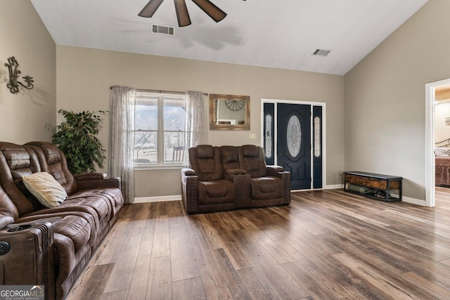 living room with lofted ceiling, hardwood / wood-style floors, and ceiling fan