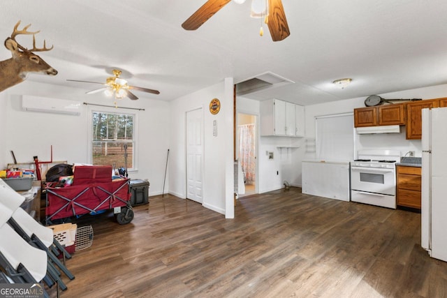 kitchen with ceiling fan, dark wood-type flooring, a wall mounted air conditioner, and white appliances