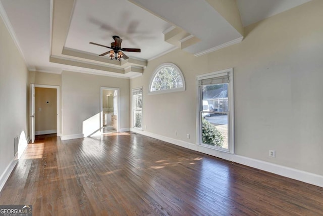 unfurnished living room with dark hardwood / wood-style floors, ornamental molding, a raised ceiling, and ceiling fan