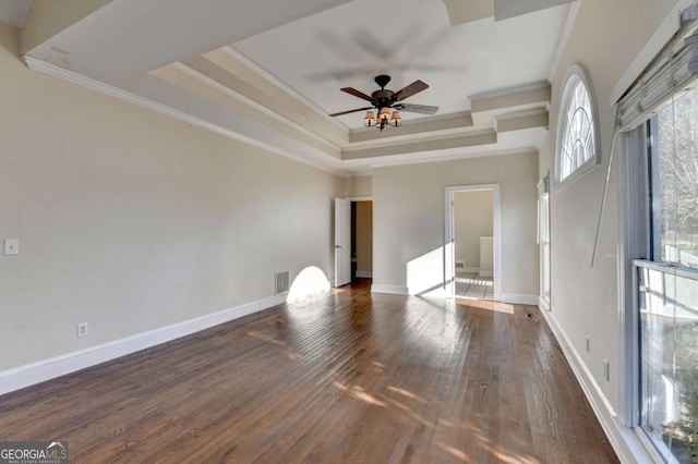 interior space featuring crown molding, dark wood-type flooring, a raised ceiling, and ceiling fan