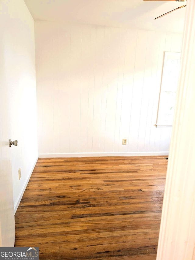 empty room with hardwood / wood-style flooring