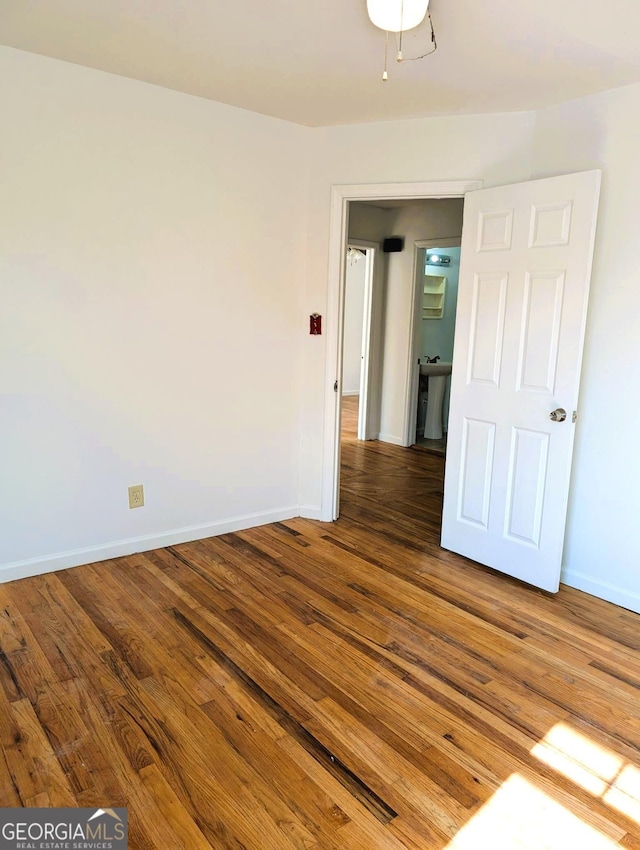 empty room with hardwood / wood-style flooring