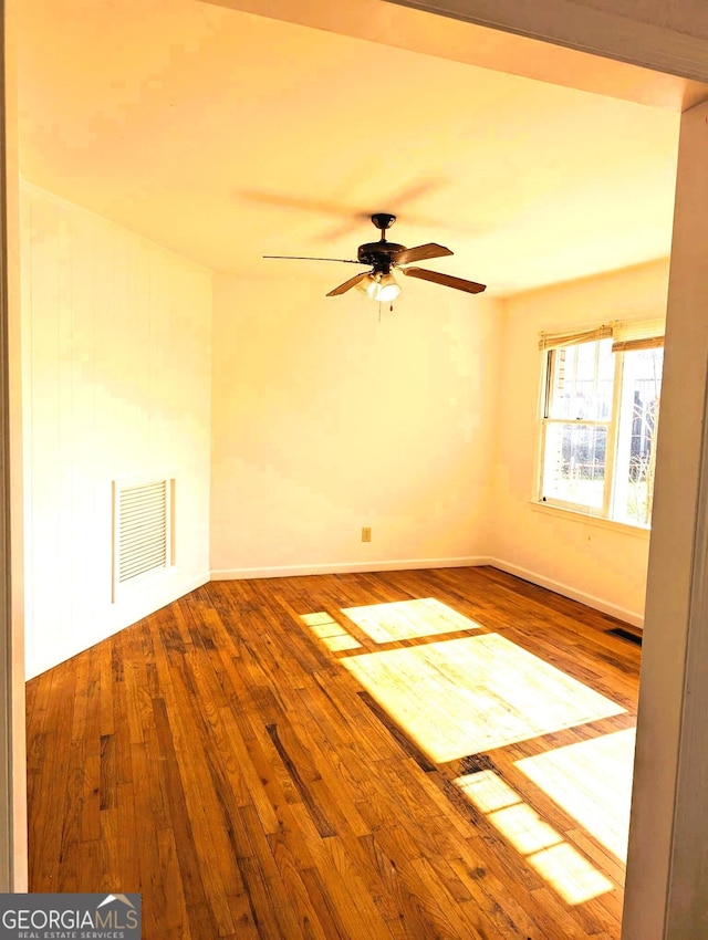 unfurnished room featuring hardwood / wood-style flooring and ceiling fan