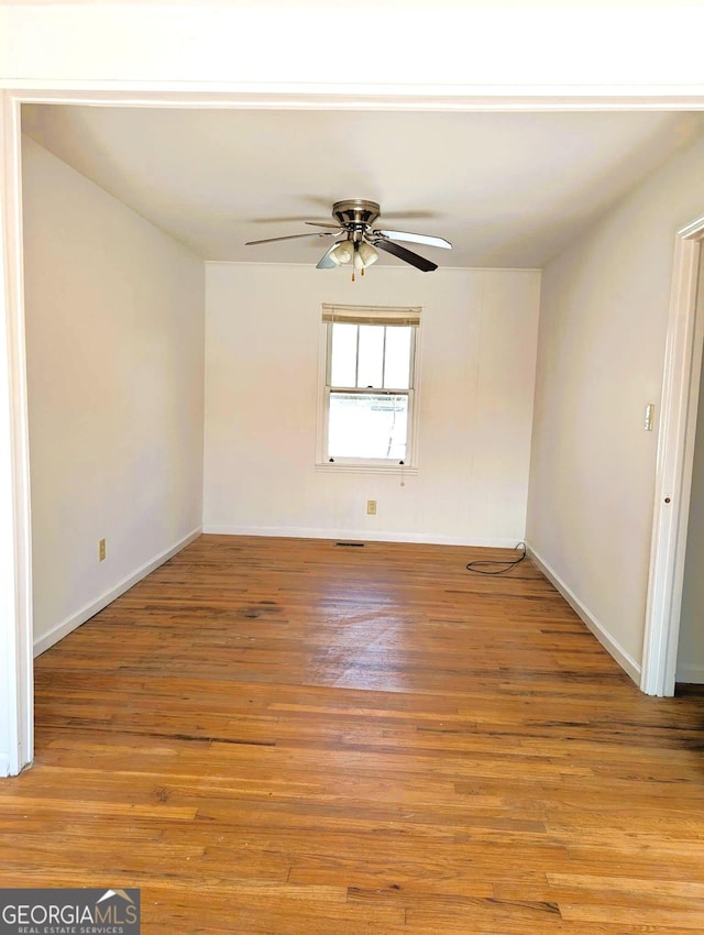 empty room featuring ceiling fan and light wood-type flooring