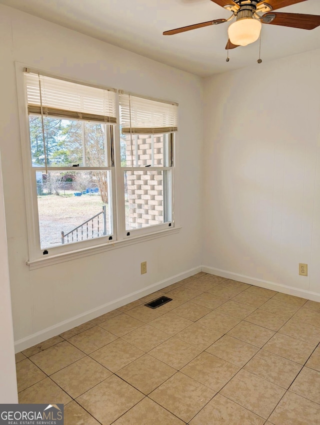 unfurnished room with ceiling fan and light tile patterned flooring