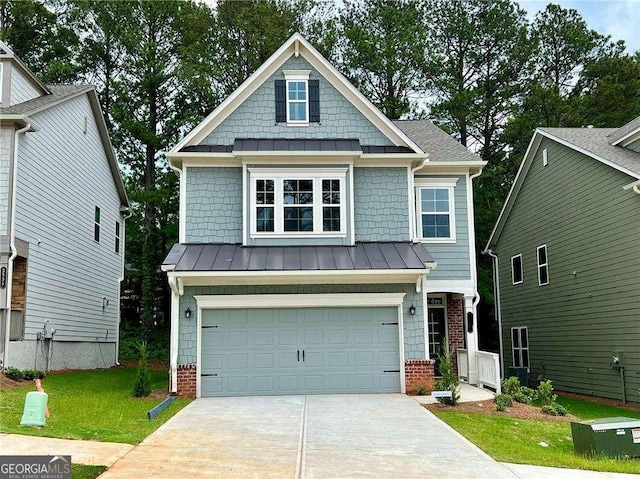 craftsman house with a standing seam roof, brick siding, driveway, and an attached garage