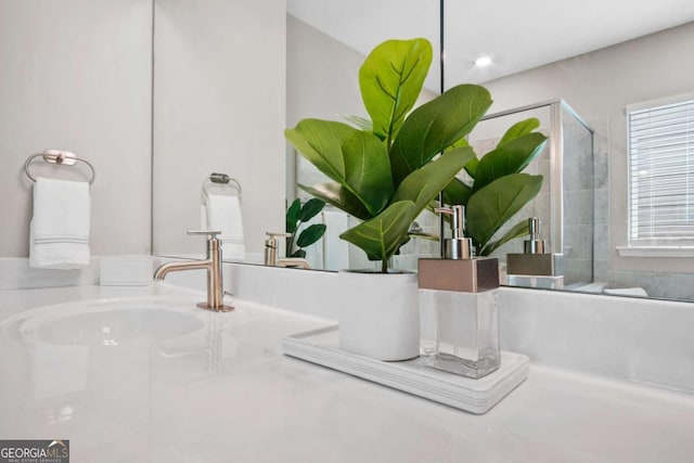 interior details with a stall shower and a sink