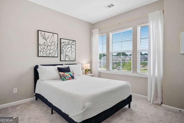 bedroom featuring baseboards, visible vents, and carpet flooring