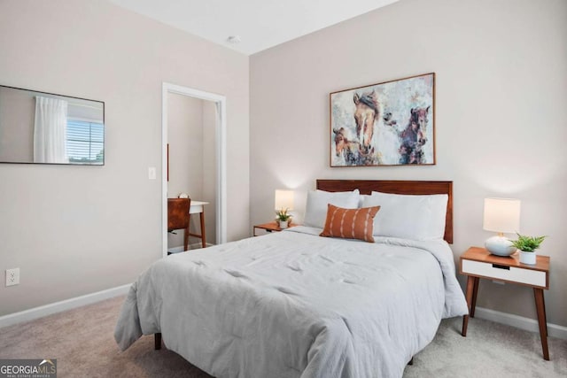 bedroom with light carpet and baseboards