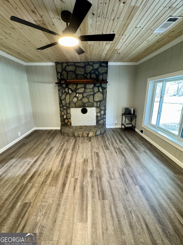 unfurnished living room featuring crown molding, ceiling fan, a fireplace, wood-type flooring, and wooden ceiling