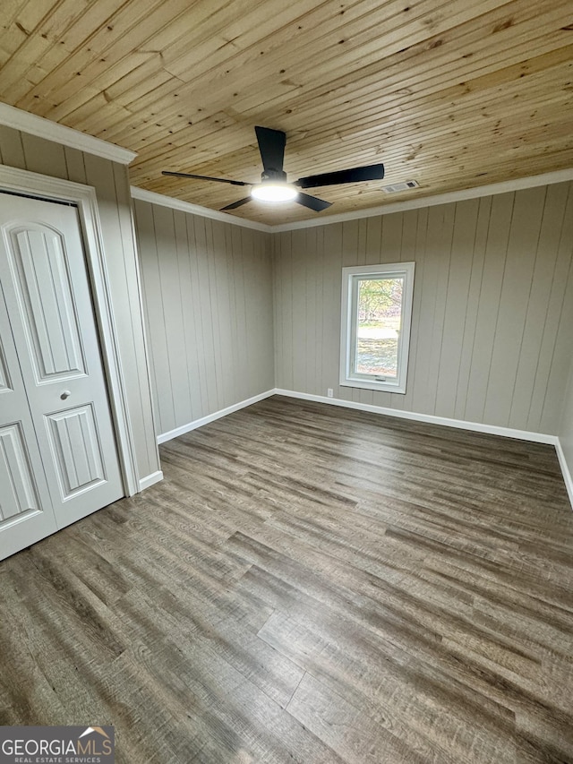 unfurnished bedroom with wood ceiling, ceiling fan, crown molding, and light hardwood / wood-style flooring