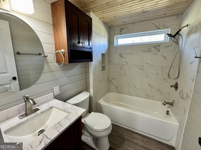 full bathroom with toilet, wood walls, wooden ceiling, vanity, and tiled shower / bath combo