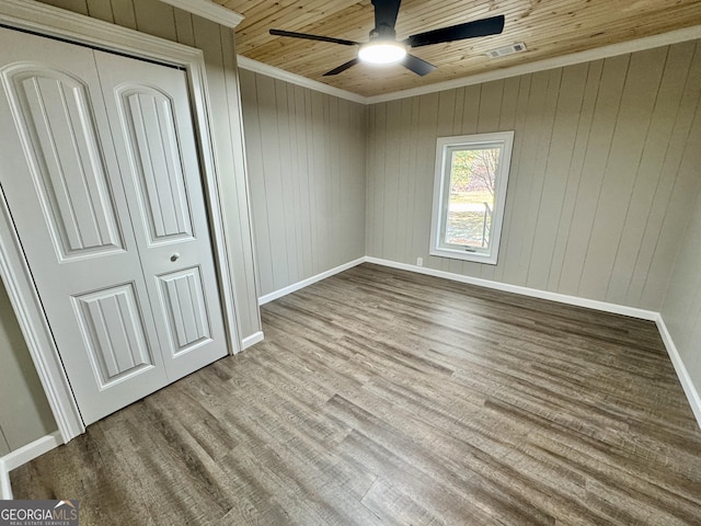 unfurnished bedroom with a closet, ornamental molding, wooden ceiling, and light hardwood / wood-style flooring